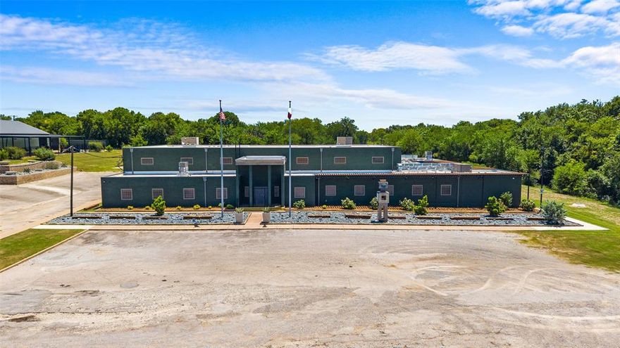 The Armory at 1400 Gribble - a 24,291sq ft estate on 9.36 acres. Originally a 1920s TX Natl Guard Armory, home to 111th Engineers & Thirty-Sixth Div, this property blends historic charm with modern luxury, ideal for corp hdqrts, event venues, secure facilities, mixed-use dev, or private estate. Situated 1 mile from the I.T. corridor, driven by over $40BB in tech invstmts, incl TX Instruments’ $40BB semiconductor campus & GlobalWafers’ $5BB silicon wafer facility, it benefits from Sherman’s $500MM infrastructure upgrades, including water & wastewater systems, Hwy 75 enhancements, & new airport hangars, supporting a population boom potentially doubling to 90,000 in 5 to 10 yrs. Tyson Foods’ expansion & downtown revitalization add vibrancy. SEDCO incentives, incl tax rebates & grants enhance ROI. The 120x60ft Great Hall features 20ft ceilings, 2 10-ton AC units, a 25ft HVLS Big Ass fan, seamless polyaspartic flooring, 12 Sonos HiFi speakers, & Perennial fabric roller shades. Indoor gun range offers 415-yard lanes, PEPP soundproofing, 5K CFPM HEPA scrubbing ideal for security or firearms use. Kitchen showcases a La Cornue Grand Palais 180 range, nickel quartzite waterfall countertops, Kohler sinks, a 90-second commercial dishwasher, & basalt mosaic flooring. Gameroom incl a Beverly Blue quartzite wet bar, 1890s Welsh slate snooker table, antique stained-glass lighting, & cherrywood cabinetry. Main bedroom suite has an original munitions safe, marble-floored bathroom with Kohler Real Rain shower, 2 Napoleon fireplaces, & Cambria quartz countertops. Patio features a Napoleon outdoor kitchen with a 6ft remote-controlled fireplace & flagstone paving. The 5,300sq ft annex has 25ft ceilings, 2 3-ton AC units, Sonos speakers, 12-camera surveillance, & 2 car lifts. Tech & security include 18-camera surveillance, high-speed internet with dedicated IP, & 2 vaults. Just one-eighth mile from Sherman Mun Airport, The Armory leverages Sherman’s tech growth & proximity to Lake Texoma.