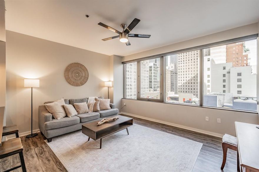 Ready for immediate occupancy! Great one bedroom with terrific Eastern interior Downtown and the 6th floor pool and amenities deck. This condo features wood floors in the kitchen, entry and living area.  New carpeting was recently installed in the bedroom. The kitchen includes with stainless appliances, black granite counters and breakfast bar. Building amenities to include a rooftop pool, jacuzzi, outside grill and lounge areas, fitness room and amazing city views! One assigned parking space in the secured upper garage (Main Street entrance).  Currently fully furnished, but can be removed by request.