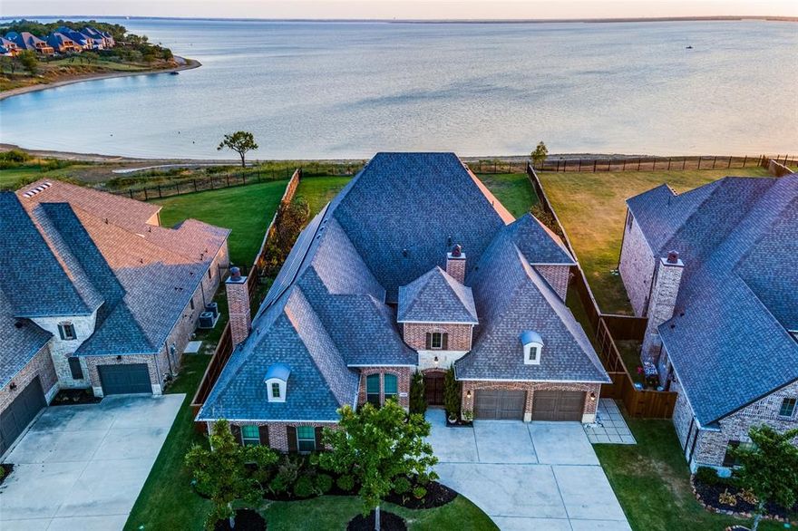 Your DREAMHOUSE LAKEVIEW awaits you in the highly sought after The Tribute Golf & Resort Community. Home boasts MANY upgrades from solar panels to battery power grid... COMPLETELY paid off. Offering 4 bedrooms & 4 full baths with primary & 2 bedrooms downstairs. Plantation shutters are nestled in the dining room, office & secondary bedrooms downstairs. Wood floors greet you as you enter the home & throughout most of first floor. Bedrooms have beautiful upgraded marble flooring. The kitchen comes equipped with high end appliances from Wolf 6 burner gas range to Cafe double ovens with air fryer built in. The showers are all steam and baja. The courtyard is the perfect spot to sit & relax after a long day while enjoying privacy & cozy fireplace. The backyard comes with retractable screens perfect for shading on a hot summer day. Spiral staircase on back patio takes you to extended balcony with 180 views of Lake Lewisville. The options are endless on this half acre lot! Come see it today!