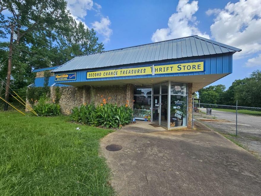 Versatile Commercial Opportunity on 3.51 Acres! Positioned just off the main highway, this expansive 25,818 sq ft warehouse offers endless potential. The structure features multiple bay doors for easy access, temporary interior walls with drop ceilings, and a loft-style area ideal for storage or a break room. Several restrooms throughout enhance functionality for various operations. Fully fenced for added security and privacy, this property is perfect for warehousing, light manufacturing, distribution, or redevelopment. Don’t miss this rare chance to own a high-visibility, high-capacity commercial site!