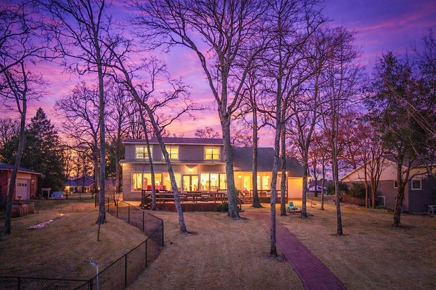 Lovingly owned for over 20 years, this well-maintained water front home in one of Cedar Creek Lake’s most sought after subdivisions is finally hitting the market. Offering approximately 2,950 sq ft of thoughtfully designed living and entertaining space, the home features  4 bedrooms, 4 bathrooms, an additional dining nook, and a versatile flex space-providing plenty of room for the whole family and guests. Remodeled in 2020, this home seamlessly blends timeless finishes with everyday functionality and a wall of windows showcasing beautiful lake view and hand scraped hard wood floors. The kitchen is designed for gathering, complete with quartz countertops, bar seating, under-cabinet lighting, stainless steel appliances, a built-in bar with wine refrigerator, and a dedicated coffee station with warming drawer. The primary suite showcases peaceful lake views, patio access, a soaking tub, separate shower, dual vanities, and a walk-in closet with custom built-ins. Upstairs offers a third bath with double sinks and 2 water side bedrooms- one is ensuite with 4th bath and the other large enough to accommodate several bunk beds. Additionally, there is a flex room seller is using as a small additional sleeping area but would also make great storage or hobby room. Outdoor living truly sets this property apart. Enjoy a covered patio, expansive deck, paved walkway to the boathouse, and a large backyard shaded by mature trees. The boathouse features a boat lift- with a newly replaced oversized motor (2025), jet ski lift, and a party deck overlooking the open cove to open water. Front driveway accommodates up to six vehicles, in addition to a one-car garage with front and rear pull-through access providing convenient water toy storage. A rare opportunity to own an exceptional lake property designed for both relaxation and entertaining. Property offered partially furnished including some water toys. See MLS documents for list.  Watercraft available separately.