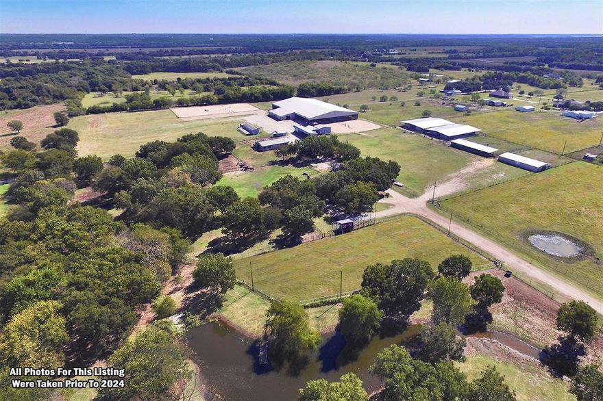 Conveniently located just off Fm428 and a mere 3.5 miles from Loop 288, this versatile 30-acre horse property with a home and large covered arena will cater to a diverse range of interests.  Ideally situated between Denton and Aubrey, it serves as an optimal location as a dream equestrian facility, an income-producing property, or a variety of other endeavors.  The property's features highlight a nice 3-bedroom ranch-style home, a fabulous 150'x250' covered arena with lights, and an attached 42x84 insulated block barn with 8-12x12 stalls, dual wash bays, and a large tack room with a swing out saddle rack.  There's also a separate 36x60 center aisle barn with 8-12x12 stalls, and additional outbuildings housing additional temporary stalls.  Further enhancing its appeal, there's an outdoor arena, an office with a full bath, two storage buildings, RV and vendor connections, a concession stand, a public bathroom, and a separate 3-bedroom mobile home.  Currently used for boarding and hosting horse show events, the property offers adaptability for personal use or exploring alternative opportunities.  The land has lots of character, with a rolling pasture and a creek meandering through a grove of pecan trees in the front half. It is set in a small acreage neighborhood and just off Farm to Market 428, about 5 minutes from Loop 288, which loops around Denton with direct access to I-35, US Hwy 380, shopping, dining, a water park, and Sherman Drive.