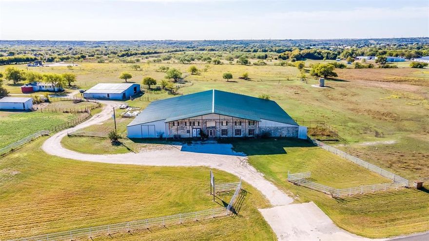 Exceptional 29.168-Acre Multi-Use Property with Highway Frontage
Discover a rare opportunity to own 29.168 acres of prime land with 798 feet of Highway 377 frontage, ideal for commercial, residential or agricultural ventures. This versatile property, located in Aledo ISD, and features a substantial 18,000 sq ft multi-use building, previously operated as a veterinary clinic, 14,000 sq ft is the dirt floor arena, with approximately 4,000 sq ft of enclosed space and 2,000 sq ft equipped with central heat and air. The building is serviced by a dedicated water well, ensuring reliable water supply.
The property is fully fenced and cross-fenced, offering flexibility for livestock, farming, or other uses. Located less than a quarter of a mile from the prestigious Blue Jack Ranch Golf Club, currently under construction, this site benefits from its proximity to a developing luxury destination. Whether you envision a commercial enterprise, agricultural operation, or a unique development project, this one-of-a-kind property offers endless possibilities. Don’t miss your chance to secure this exceptional investment.