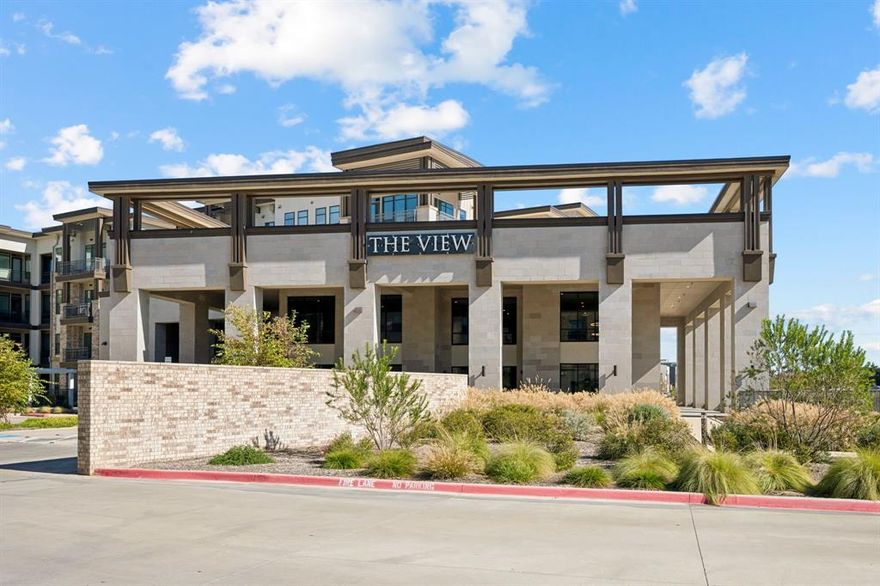 Discover modern luxury in this beautifully appointed 4th-floor condominium at The View. Nestled among lush greenbelt surroundings, this residence offers a serene living environment with an open-concept layout featuring 10-foot ceilings, quartz countertops, a spacious breakfast bar, premium finishes, wood flooring, and abundant natural light. The unit is move-in ready and includes a refrigerator along with a brand-new washer and dryer. Residents enjoy an exceptional collection of resort-style amenities, including five elevators, secure controlled access, a state-of-the-art fitness center, yoga studio, resident lounge, conference rooms, game lounge, and multiple WiFi-equipped co-working spaces ideal for remote work. Outdoor amenities include a resort-style pool with water features and lounge seating, a dog park, bike storage, and direct access to the scenic Nob Hill Greenbelt walking, jogging, and biking trails. The beautifully landscaped courtyard—complete with a stone plaza and tranquil water features—provides a peaceful retreat at the heart of the community. Conveniently located near H-Mart, 99 Ranch Market, Walmart, Lowe’s, and a wide variety of restaurants and shopping options, this residence offers outstanding accessibility. Quick access to I-35, TX-121, and the George Bush Turnpike makes commuting throughout the DFW Metroplex, including DFW Airport and Dallas Love Field Airport, exceptionally convenient. On-site retail within the community further enhances everyday convenience. Resident parking is located within a comfortable walking distance from the building and the unit. Experience a lifestyle that blends comfort, wellness, convenience, and resort-quality amenities in one of Carrollton’s most desirable communities. This property offers exceptional privacy, accessibility, and location—all in one.