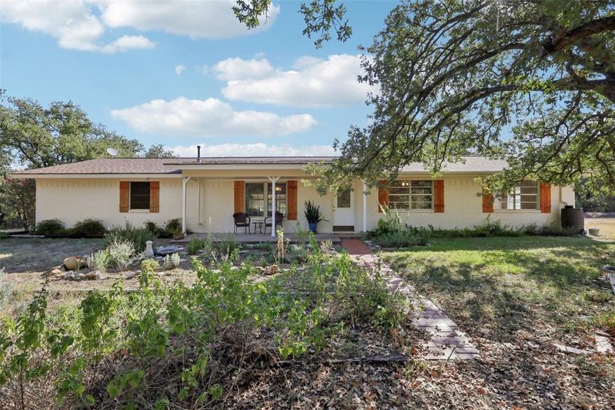 Beautiful country home on 5 plus acres, fully fenced and surrounded by mature trees and gardens. Features 3 bedrooms, 2 baths, and multiple living areas including a living room, dining room, sunroom, second living area that could be turned into a mother in law suite, and an office. The kitchen offers a walk-in pantry, and the extra large laundry room provides extra storage and a second fridge. The living room has a cozy wood pellet stove for efficient heating during the winter. Outside enjoy flower gardens, a greenhouse, garden area, 2 storage buildings, and a pond. A 2-car carport with extra storage adds convenience, plus a small fenced area off the back door for pets or play. Property is fully fenced. Includes reverse osmosis water system, small generator, Starlink internet system available, and a private RV or tiny home site with electric, water, and septic, perfect for an aging parent or that kid that wont move out. All appliances convey. A peaceful country setting with room to garden, grow, and enjoy the quiet life.