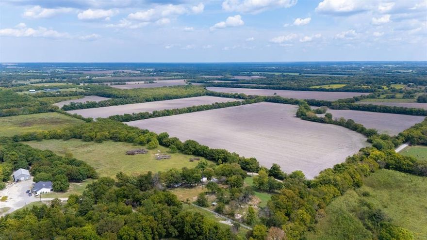 Exceptional 314 acre ag exempt ranch in Trenton, Texas offering a rare combination of topography, location, and improvements. The property features a seasonal creek, rolling terrain, and elevated vantage points that deliver breathtaking sunrise and sunset views. Improvements include a 120x130 covered arena, a 17 stall barn, and additional facilities that make the ranch ideal for equestrian, livestock, or recreational use. Open pastures blend with scenic elevation changes, creating a diverse landscape that is both beautiful and practical. Conveniently located with easy access to Highway 69 and Highway 121, the ranch is approximately one hour and fifteen minutes from DFW International Airport, less than an hour from McKinney, and a short drive to Sherman. This unique tract offers the perfect balance of ranch lifestyle, investment potential, and accessibility in one of North Texas’s most desirable growth corridors.