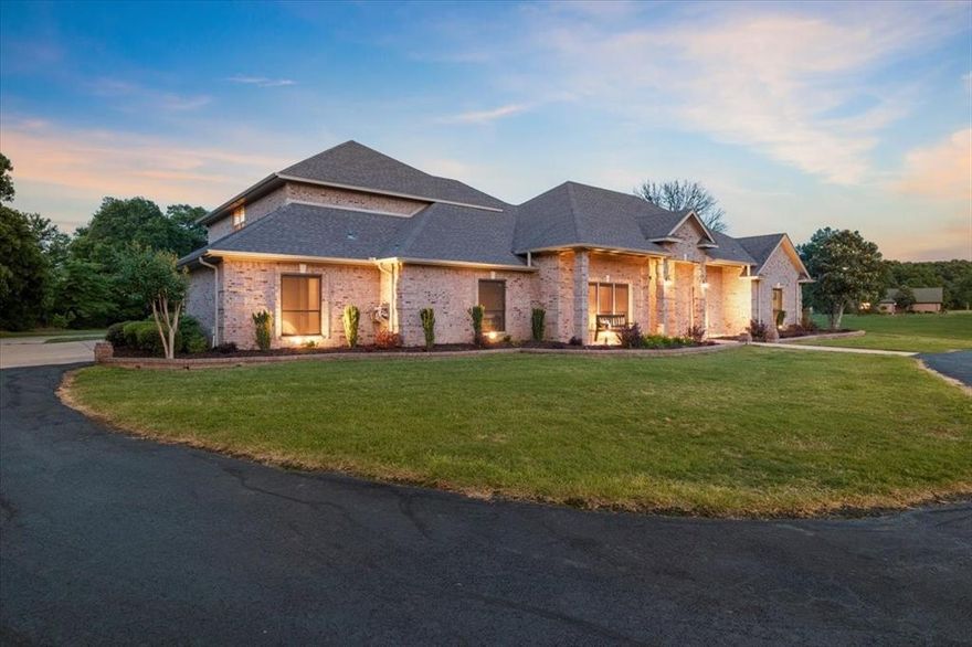 This exceptional 11-acre estate truly has it all — luxury living, recreation, privacy, and versatility — just minutes from Paris, Texas.

The beautifully designed main residence offers 4 bedrooms and 3.5 bathrooms with a thoughtfully designed split floor plan. The private primary suite occupies its own wing, featuring direct patio and pool access, a spacious spa-style ensuite bath, and an oversized walk-in closet. Two additional downstairs bedrooms share a Jack-and-Jill bath, while a fourth bedroom or bonus suite is located above the garage with its own full bath and generous storage — ideal for guests, multigenerational living, or a quiet retreat.

The main living area showcases soaring ceilings and expansive open spaces designed for both everyday comfort and entertaining. The oversized living and dining areas flow seamlessly into the kitchen, which features custom wood cabinetry and a breakfast nook overlooking the covered patio and saltwater inground pool.

A circular front drive welcomes you home, while a full concrete drive extends to the rear of the property where a 50x70 insulated shop with covered parking provides exceptional flexibility. The shop is suitable for a workshop, gym, RV storage, boat storage, or business use. Attached is a fully finished clubhouse complete with entertaining space, kitchenette, bathroom, two sleeping areas, and a deck — offering excellent guest accommodations or potential income-producing opportunity.

Beyond the improvements, a stocked ¼-acre pond with crappie and bluegill adds to the property’s recreational appeal. The land extends into mature trees, creating privacy and natural beauty across the full 11 acres.

This property offers the rare combination of luxury home, acreage, pool, pond, shop, secondary living quarters, and prime location — all in one turnkey estate. Schedule your tour today!