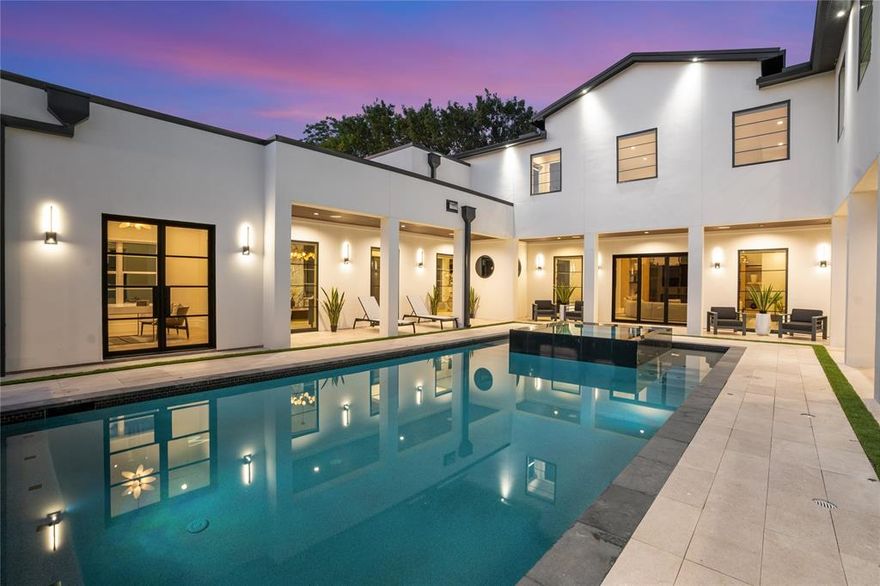 Completed in 2025, this custom-built masterpiece at 5510 Caladium delivers elevated luxury and thoughtful design in one of Dallas’s most sought-after neighborhoods. With over 6,200 square feet, five bedrooms, and striking architectural detail, this home offers both grand entertaining spaces and intimate retreats.

From the moment you enter, you are welcomed by soaring 22-foot ceilings, expansive natural light, and serene pool views. To the right of the entry, a formal living space with fireplace opens to an oversized study with floor-to-ceiling windows. To the left, a sitting area flows into the dramatic great room with 22-foot ceilings and seamless views of the dining and wine rooms. The chef’s kitchen is the heart of the home, featuring a large island, Thermador and Wolf appliances, a Gaggenau espresso station, steam oven, pot filler, wine storage, and a walk-in pantry. Just off the kitchen is a spacious laundry with two stackable washer and dryer sets.

The first floor features a luxurious primary suite with dual walk-in closets, spa-inspired bath, and private outdoor access to a putting green and yard. Another generously-sized downstairs bedroom suite is perfect for guests or intergenerational living.

Upstairs, a lounge leads to the game room with built-ins, a wet bar, and a covered balcony with views of the pool. Entertaining options continue in the media room with Wolf microwave and Thor wine fridge. A powder bath and three additional bedrooms - one ensuite - complete the second floor.

Step outside to a resort-style oasis with sparkling pool and spa, water features, covered outdoor kitchen with Hestan grill, pergola, and multiple seating areas. A three-car garage completes this exceptional property.

5510 Caladium is more than a home - it is a lifestyle, offering the perfect balance of sophistication, comfort, and resort-style living in the heart of Dallas.