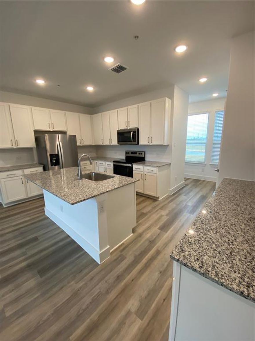 This unit is a three bedroom, 2 bath floor plan, on the ground level, private entrance & private yard. 1255 square feet, wood style floors, smart lock on the front door, washer & dryer included. New construction community, brand new units!