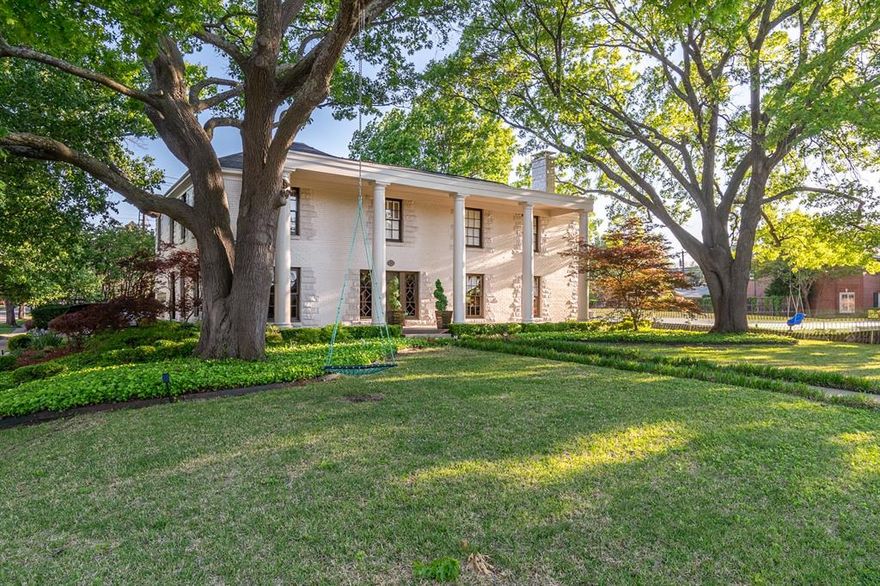 This nostalgic colonial house sits on a coveted oversized corner lot surrounded by majestic and priceless trees. The wide spanning front porch with towering columns sets the theme for this property: historical charm combined with spacious yet cozy layout for modern living.  The front formal living area overlooks the gorgeous front yard and also has windows facing the backyard outdoor kitchen and pool area.  Beautiful hardwood floors flow throughout and the bricked flooring in the study is another charming touch. The kitchen, butlers & breakfast area boasts granite counters, stainless appliances, and lots of natural light. What was originally a screened breezeway connecting the house to the garage and quarters was later converted into a perfect back family den with fireplace, plenty of space for oversized comfy furniture, and french doors leading to the backyard and pool. Don't miss the opportunity to live in and love this neighborhood classic and come make this house your own.