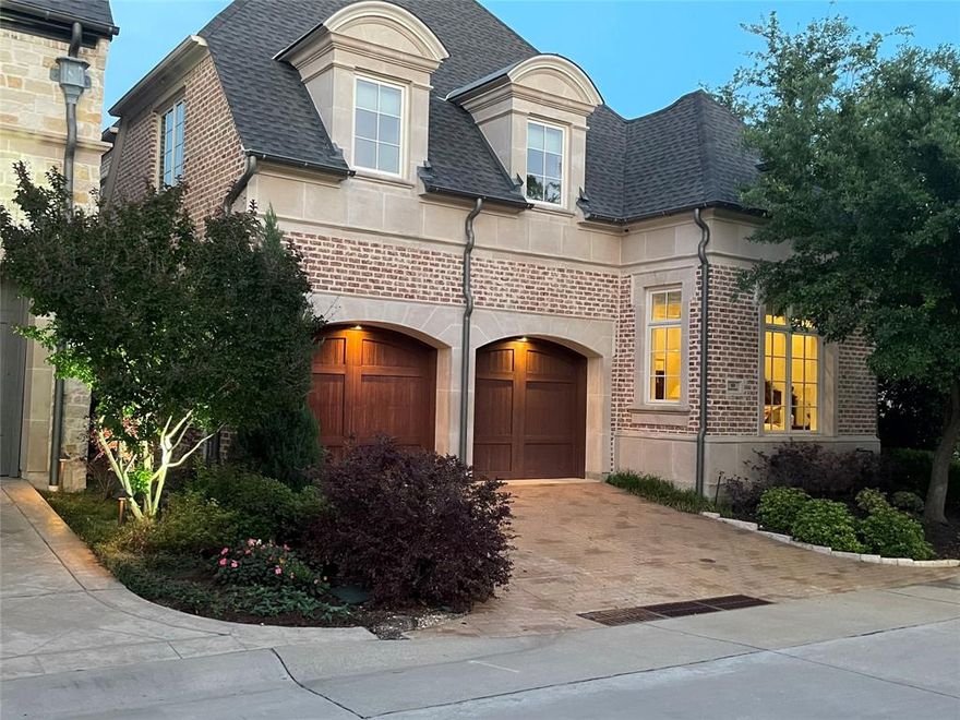 This exceptional home is ideally situated on an interior corner lot within the prestigious, gated community of The Lawn at Glen Abbey, featuring a security-guarded entrance. The thoughtfully designed floor plan offers a first-floor primary suite overlooking a beautifully landscaped greenbelt, along with a separate guest or mother-in-law suite privately located on the opposite side of the home. The chef’s kitchen is equipped with top-tier appliances including a Wolf 8-burner gas range with double ovens, Asko dishwasher, SubZero refrigerator&freezer, and SubZero wine refrigerator. A private office provides the perfect work-from-home space, while the spacious main living and dining areas showcase soaring ceilings and an abundance of natural light with views of beautiful, mature landscaped greenery. Upstairs, enjoy a second media or game room and two additional bedrooms. Additional highlights include an elevator equipped closet, ample storage throughout, and a covered brick patio off the main living area - ideal for entertaining or enjoying a quiet, private retreat.