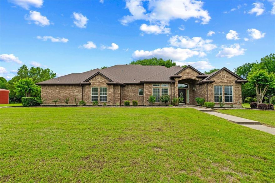 Located near the peaceful shores of Waxahachie Lake, this beautifully maintained custom home offers the perfect blend of space, comfort, and everyday functionality. Situated on a generously sized lot with mature trees and exceptional backyard shade, 231 Ash Drive provides a private, relaxed setting while still being close to shopping, dining, schools, and major commuting routes. The timeless brick exterior, oversized driveway, and spacious 3-car garage create an inviting first impression.

Inside, the thoughtfully designed single-story layout features 3 bedrooms, 2.5 bathrooms, large living and dining areas, rich wood laminate flooring, crown molding, tall ceilings, natural light, and custom built-in cabinetry throughout the main living. The oversized living room is anchored by a striking brick fireplace and flows into the kitchen and dining areas, making the home ideal for both entertaining and everyday living.

The kitchen has been recently updated in 2025 including new kitchen countertops, double ovens, induction range, hood vent, and kitchen sink. Extensive cabinetry, generous prep space, stainless appliances, a center island, and breakfast bar provide functionality and timeless style.

The spacious primary suite offers tray ceilings, large windows, and a relaxing ensuite bathroom complete with dual vanities, soaking tub, separate walk-in shower, and large walk-in closet. Secondary bedrooms are generously sized and thoughtfully positioned within the home.

One of the standout features of this property is the backyard. The oversized covered patio creates the perfect space for outdoor dining, entertaining, or simply enjoying peaceful evenings surrounded by mature shade trees.

Located just minutes from Waxahachie Lake, Downtown Waxahachie, and a quick trip tp Ft Worth or Dallas... this property offers the rare combination of privacy, outdoor enjoyment, and convenient access to everything Waxahachie has to offer.