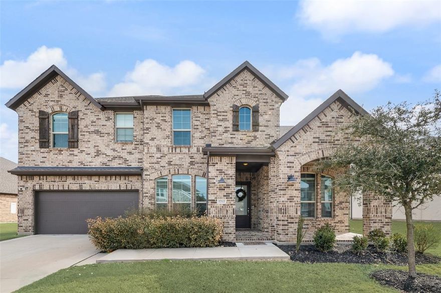 Ideally positioned on nearly a quarter acre of land in the highly sought-after Southpointe community of Mansfield, this recently built K. Hovnanian home offers over 3,200 sq ft of thoughtfully curated living, featuring four spacious bedrooms - including a private primary suite and a guest suite with its own ensuite bath downstairs, perfect for visitors or multigenerational living. A handsome study tucked behind french doors welcomes you at the entry, while the elegant dining area sets the stage for hosting and entertaining. At the heart of the home, a striking chef’s kitchen showcases a gas range, double ovens, farmhouse sink, tall cabinetry, and an impressive gathering island, flowing seamlessly into a warm family room anchored by an inviting fireplace. Soaring ceilings and abundant windows fill the space with natural light, beautifully highlighting the durable wood-look tile flooring that extends throughout the main living areas. The spacious primary retreat features a spa-inspired bath with dual vanities, an oversized shower, soaking tub, and generous closet - creating the ultimate sanctuary to unwind at the end of the day. Upstairs, a large game and two additional bedrooms with ample closets offer the perfect setting for play, homework, movie nights, and everyday living. Don’t miss the desirable three-car garage, a practical mudroom, a spacious laundry room, and a convenient powder room near the patio - perfectly positioned for when you add a pool and create your private, expansive backyard oasis. Residents enjoy resort-style amenities, including a 4,000-sq-ft clubhouse, pool, fishing ponds, parks, playgrounds, miles of walking trails, and highly regarded Mansfield ISD schools. Conveniently located near Highways 360 and 287, the home is less than 30 miles from downtown Dallas, downtown Fort Worth, and DFW Airport—placing you in the heart of the Metroplex with abundant shopping, dining, and entertainment just minutes away.