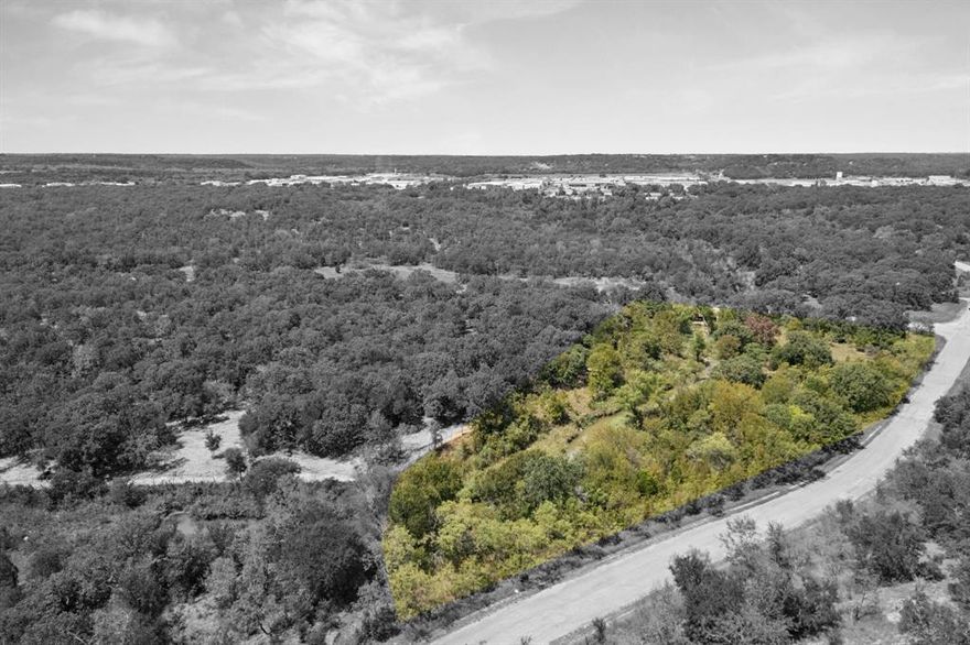 Discover the potential of 3+ acres in the heart of Mineral Wells — now proudly known as the Wellness Capital of Texas. This corner lot offers excellent visibility and flexibility with current commercial zoning and the likelihood of future residential zoning. Situated within the city limits, city utilities are nearby for added convenience.
Just minutes from downtown Mineral Wells, this property puts you close to the town’s exciting revitalization, rich history, and vibrant small-town charm. Enjoy proximity to the golf course, shopping, dining, and community attractions, with easy access to surrounding towns and major cities.
Whether you envision a business location, residential development, or investment for the future, this versatile tract offers a rare opportunity to secure land in a growing and desirable market.