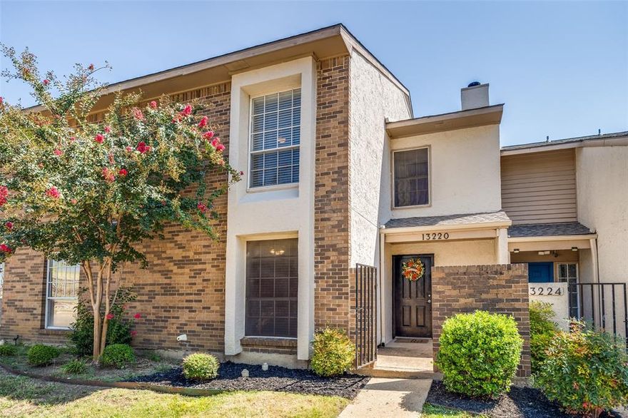 Welcome to 13220 Woodbend Lane, a beautifully appointed townhome that combines thoughtful updates, convenience, and community amenities.
Inside, you’ll find wood-look flooring throughout. No carpet anywhere. The living room, filled with abundant natural light, showcases soaring double-height ceilings and a cozy wood-burning fireplace. Flowing seamlessly from the living area is the bright dining space and the updated kitchen, complete with stainless steel appliances, granite countertops, and a breakfast bar. Nearby, the utility room includes a washer & dryer along with ample pantry storage space. The downstairs primary suite offers a spacious walk-in closet and a bathroom featuring dual vanities and an updated, floor-to-ceiling tiled shower. A stylishly finished half bath for guests completes the lower level.

Upstairs, two generously sized bedrooms share a full bathroom with dual vanities. One of the bedrooms enjoys direct access to the bath, making it ideal for housemates.

Outdoors, a private patio enclosed by a wood privacy fence provides a welcoming retreat. Two dedicated covered parking spaces and a secure storage closet finishes out this property. 
Recent updates include a new roof, installed within the last year, with level-four impact-resistant shingles. Community amenities include two pools, tennis courts, and a clubhouse, all maintained by the HOA. Enjoy quick access to a quiet walking trail encircling a pond overlooked by this property. 

This home is move-in ready and a wonderful find, whether you’re seeking a low-maintenance lock-and-leave lifestyle or a valuable addition to your investment portfolio.