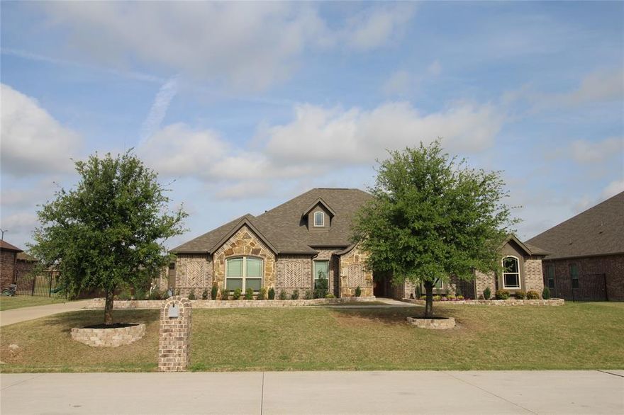 Gorgeous 1 story Dream Home on oversized 100x150 lot with a salt water pool, covered patio and an outdoor living space.  No MUD and No PID! This open floor plan has a large eat in kitchen and island, granite counter tops, separate prep sink and SS gas appliances.  Custom cabinets galore with planning desk just off the breakfast area and a walk in pantry. Work from home in your spacious study with French doors, and entertain in your huge great room with stone fireplace.  Wood style tile floors for easy cleaning and perfect for pets.  Laundry room has a sink and cabinets for storage.  3.5 Car garage spaces have epoxy floors with passage door to back yard with iron fencing and wonderful landscaping. Storage-work cabinets & ceiling storage racks in garage. Exterior up-lighting on front of house with holiday light package. And so much more.