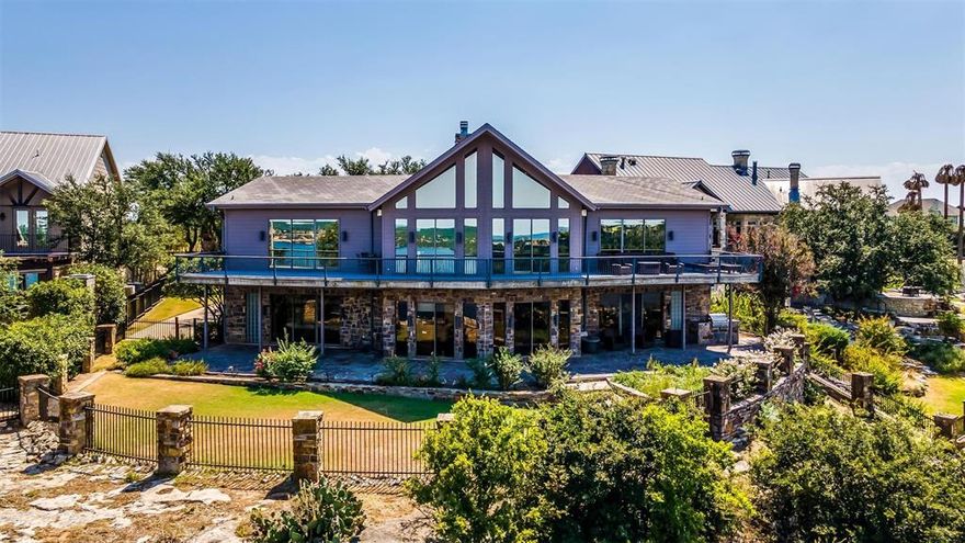 The most absolutely stunning view awaits you as soon as you walk into this gorgeous home. This phenomenal home sits on a fabulously unique lot in that in extends out past the neighboring homes and gives you a one of a kind water and sky view.  Floor to ceiling windows afford you 180 views of the brilliantly blue waters, the resort, and the golf course. With 2 adorable bunk rooms this home can comfortably sleep 12 people. Sliding doors in the first level den open out to the covered patio, backyard, and the incredible 200' cliff line.  Upstairs living gives your more opportunities to take in the one of a kind view from all rooms and sliders open out to the large balcony that is the perfect place to sit and take it all in.