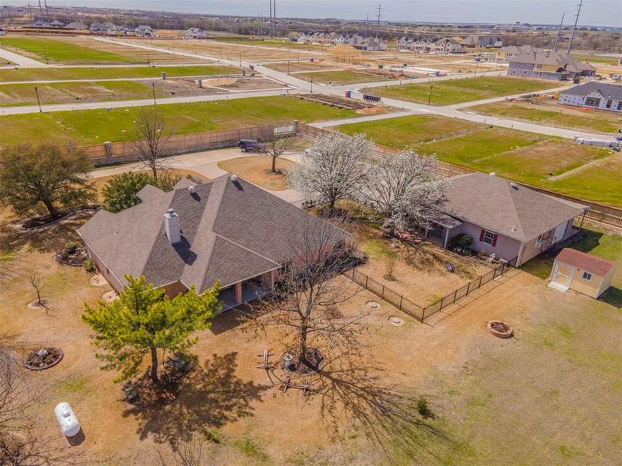 Welcome to your private retreat in the heart of Haslet!
Set on just over 6 peaceful acres across from Eaton High School in Northwest ISD, this 4-bedroom, 2-bath home combines privacy, comfort, and versatility—all just minutes from city conveniences.

A gated entrance and long private drive lead to a circle drive and welcoming covered porch. Inside, you’ll find a warm, functional layout featuring a cozy living room with a fireplace and built-ins. The kitchen offers granite counters, tile backsplash, stainless steel appliances, and ample storage—perfect for everyday living.

The split-bedroom layout provides space for everyone, and the primary suite includes dual vanities, a soaking tub, separate shower, and walk-in closet. The HVAC system was replaced in 2025, giving peace of mind for years to come.

Out back, the 36x45 heated and cooled shop features its own electric meter, built-in cabinets, and a covered trailer porch ideal for parking extra vehicles or equipment. The attached garage is equally impressive with epoxy floors, an attic lift, and a separate office space perfect for working from home or managing projects.

With a hail-resistant roof, private well, and aerobic septic system, this Haslet gem offers the perfect blend of functionality and Texas charm—all on 6 acres in the sought-after Northwest ISD.