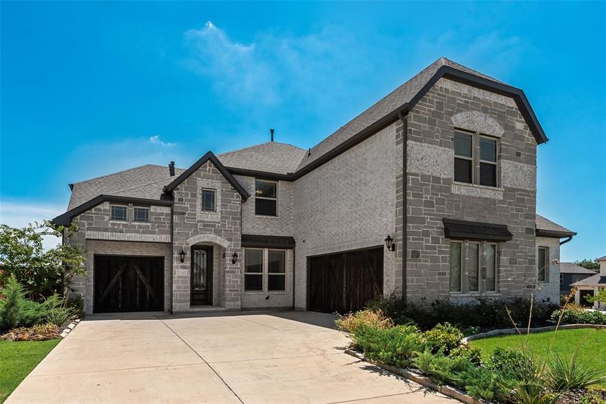 Welcome to this stunning 2-story home featuring 5 spacious bedrooms, 4 bathrooms, 3-car garage located on a massive half acre corner lot. This thoughtfully designed home offers an ideal layout for modern living, with an open-concept floor plan, soaring ceilings, and abundant natural light throughout. The chef’s kitchen boasts quartz countertops, a large island, stainless steel appliances, gas cooktop, and walls of custom cabinetry, flowing seamlessly into the main living and dining areas make it perfect for entertaining. The primary suite includes a spa-inspired bath with dual vanities, an oversized shower, and a large walk-in closet. Upstairs, enjoy a versatile game room, private media room, and generous secondary bedrooms. Outside, the beautifully landscaped TEXAS sized corner lot, covered front and back porches, extended driveway, and striking stone exterior make this home stand out. Located in a sought-after neighborhood with easy access to top-rated schools, major highways, shopping, and dining.