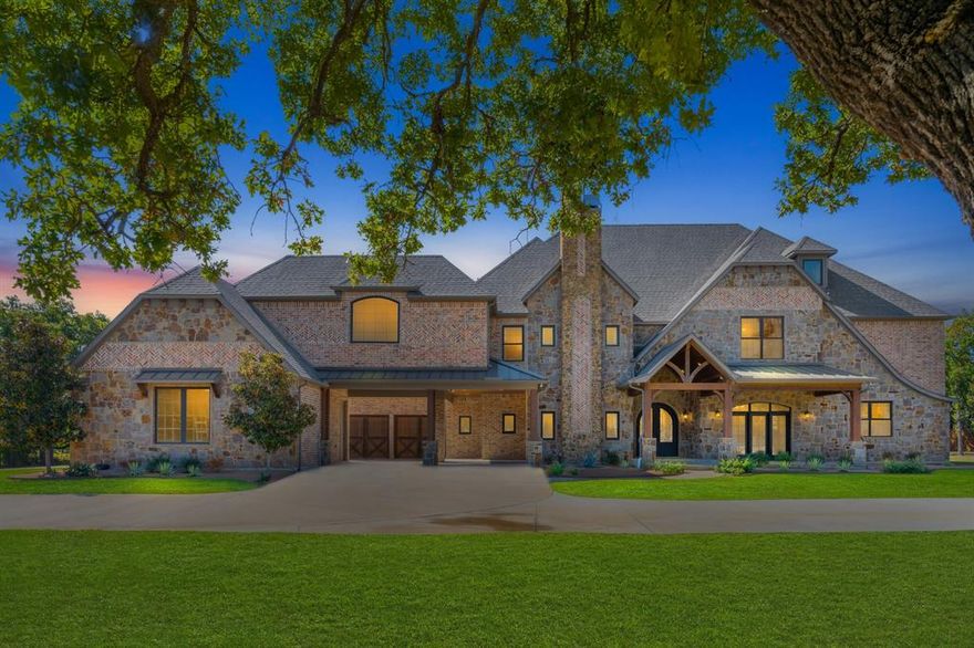 This luxury gated estate in Mansfield, TX offers a rare blend of elegance, comfort, and entertainment. Inside, you'll find an open-concept layout with soaring ceilings and real hand-scraped hardwood floors throughout the first level. The home features 4 stone fireplaces and custom built-ins, creating a warm and inviting atmosphere. The gourmet kitchen is a chef’s dream, complete with copper sinks, a built-in gas range with a pot filler, an oversized island, and a Sub-Zero refrigerator. A walk-in pantry and adjoining butler’s pantry with additional refrigerator space add convenience, while the expansive mudroom with eight cubbies provides organized storage for busy households.
The primary suite is a true retreat, featuring a stone fireplace, decorative lighting, and a cozy window seat. Its spa-inspired ensuite includes dual vanities, a walk-in dual head shower, a sauna, and a freestanding copper tub. The massive walk-in closet is outfitted with built-in dressers, cubbies, and shelving, and offers direct access to the downstairs laundry room.
The home continues to impress with a game room, media room, and a private gym. A full-size indoor basketball court adds a unique and exciting feature for active families. Each bedroom includes its own ensuite bathroom and walk in closets with built-in dressers.  With two laundry rooms—one on each level—daily routines are made easier.
Outside, the resort-style pool features waterfalls, a grotto, a slide, and a hot tub, creating a private oasis. The outdoor kitchen is equipped with a full size refrigerator, gas grill, griddle, and sink, while a nearby stone fireplace makes year-round entertaining effortless. The property includes a four-car garage and two covered carport spaces.  Plenty of space to park a RV, boat, or ATV.  RV hook up available.
This property is zoned for MISD schools and minutes away from schools making the morning commute easy.  
This estate is perfect for families who love to host, relax, and live large.