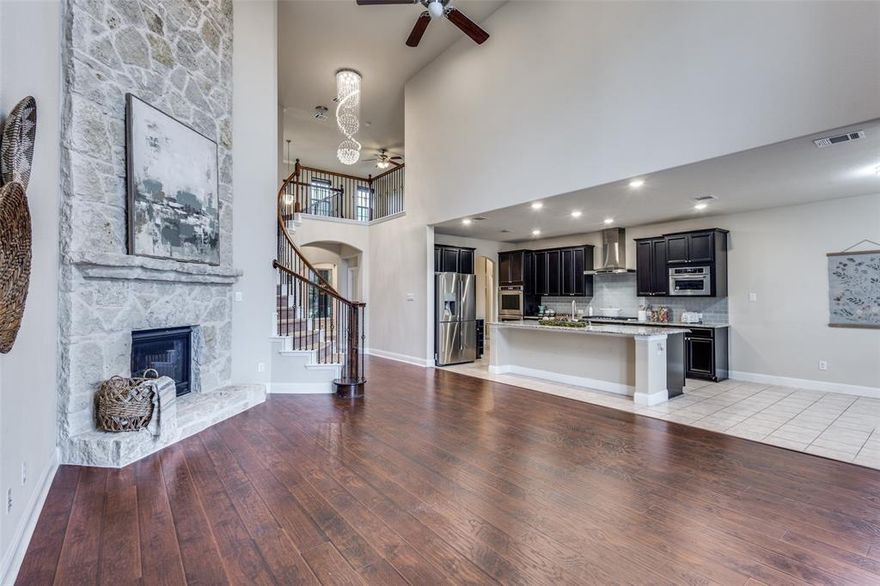 Experience a true show-stopper this former Beazer model home commanding a rare 0.34-acre corner lot in McKinney’s coveted Live Oak Creek community, where designer finishes, natural light, and an entertainer’s layout come together in one irresistible package. This impressive 5-bedroom, 3.5-bath residence (with flexible use for a private study or guest suite) welcomes you with an inviting front porch and full-length windows, leading into a bright, open-concept living area anchored by a dramatic full-size stone fireplace and views out to the expansive backyard. The chef’s kitchen is built to impress, showcasing upgraded stainless appliances, double ovens, a butcher-style island layout, rich cabinetry, and a generous walk-in pantry—ideal for both everyday living and upscale entertaining. The main-floor primary suite feels like a private retreat with an oversized walk-in closet and spa-inspired bath featuring dual vanities, a deep soaking tub, and separate shower, while the upstairs level delivers a full entertainment zone with both a game room and media room, perfect for movie nights, game days, and fun hangouts. Outside, the massive 0.34-acre lot provides a true estate-style backyard with endless possibilities for a resort-worthy pool, outdoor kitchen, play space, and lush landscaping, all set just minutes from Highway 75, shopping, dining, and well-regarded McKinney ISD schools. Homes with this level of former-model detail, lot size, and turnkey appeal rarely hit the market here—schedule your private showing immediately before this one-of-a-kind property is gone.