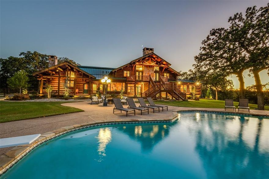 An iconic 51+ acre ranch in the heart of DFW!  Enter the gated property and be greeted by a picturesque pond and windmill.  Pass by the fully foamed horse stable with seven stalls, complete with remodeled upstairs 1800+ sq ft apartment.  This is just one of two guest homes that overlook the lighted rodeo arena.  Continue along the rolling and heavily wood property to the 8700+ sq ft authentic log home.  Recently remodeled, this rustic masterpiece boasts 4 full suites, updated kitchen with Wolf and Sub Zero Appliances.  The four car garage has been converted to an enormous heated and cooled game room with glass garage doors.  Upstairs the primary suite with cathedral ceiling offers a huge river rock fireplace and separate bathrooms.  The balcony overlooks the backyard and pool… the land sits high on a hill with views of Denton to the north.  This is truly a postcard quality property conveniently located to both Dallas and Fort Worth and just a 30 minute drive from DFW International Airport.