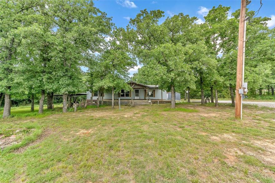Set on a stunning fully fenced 10-acre tract, this beautiful property offers the perfect blend of open grassland and trees. A welcoming front pasture is the perfect place for your horses, and yard for kids to play.  The back portion of  the property is richly wooded, providing a peaceful retreat right in your own yard.  The home features 3 bedrooms and 2 bathrooms.  The 3-stall barn with wash room is equestrian and livestock-ready.  This 10 acre homesite offers ample space and functionality for your animals.  With room to roam and relax, this peaceful acreage has endless possibilities!  Seller is motivated!
