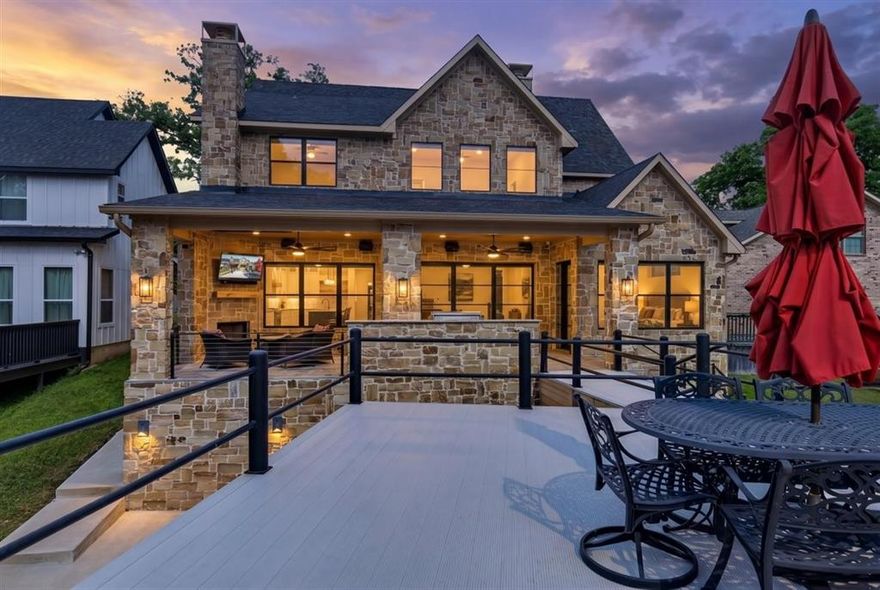 Waterfront Living, Reimagined — Where Every Sunset Is Yours! Tucked along a protected cove on Cedar Creek Lake, this stunning 2023 waterfront retreat delivers the full lake life experience endless sunsets, entertaining spaces that flow from indoors to out, and the kind of thoughtful design that makes every day feel like a vacation. Whether you're seeking a primary residence, a weekend getaway, or a high-demand short-term rental, this home checks every box. Step inside a fully integrated smart home built for those who demand both comfort and function. The chef's kitchen is the heart of the home outfitted with double ovens, self closing solid wood cabinets, warming drawer, 6-burner gas stove, and professional vented hood. A sleek wet bar with wine refrigerator and ice machine keeps the good times flowing without missing a beat.  When the evening calls for something cozy, gather around the indoor fireplace a warm, inviting anchor to the main living space. Take the party outside to the outdoor kitchen and patio. Where a second fireplace sets the perfect ambiance for cool lakeside evenings under the stars.  Then head down to your private boathouse with catwalk leading to an expansive party deck the ultimate stage for golden hour gatherings on the water. Back inside, catch a movie in the dedicated theatre room or use the flexible upstairs space your lifestyle demands. Retreat to the primary ensuite downstairs, a spa-inspired sanctuary featuring a deep soaking tub and a luxurious steam-sauna shower. Practical luxury continues with an oversized 2-car garage with epoxy floors and tankless hot water heaters. Designed for low maintenance and high reward, this home delivers the lake life without compromise. Short drive to Tool 8 Park and restaurants.  Just a little over an hour from Dallas you can be living the lake life!