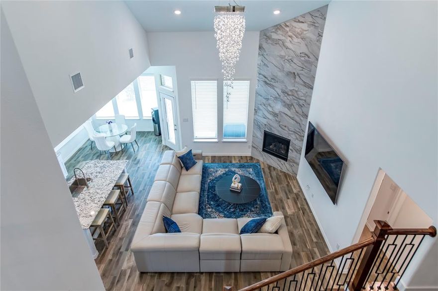 This stunning 5-bedroom, 5-bath residence combines modern design, luxury finishes, and smart-home convenience in one of McKinney’s most desirable communities.

The grand entry sets the tone with soaring ceilings, wood-look tile flooring, and a dramatic two-story fireplace. The open concept layout is ideal for effortless entertaining and everyday living.

The gourmet kitchen features a large island, granite countertops, stainless steel appliances, a WiFi-enabled oven, upgraded sink and faucet, and an oversized walk-in pantry. A private downstairs guest suite with a full bath offers a flexible option for multigenerational living or extended-stay guests. The formal dining room enhanced with barn doors and designer accent walls can easily function as a home office, playroom, or fitness space.

The primary suite delivers a true retreat with dual vanities, a frameless glass shower with dual shower heads and bench seating, and a spacious walk-in closet. Upstairs, you’ll find a generous game room, a dedicated media room, and three additional bedrooms including a Jack-and-Jill layout.

Smart-home upgrades include WiFi thermostats, a Ring doorbell, smart garage opener, and a full security system. The covered patio with upgraded tile flooring provides the perfect setting for outdoor relaxation or hosting.

Community amenities include a pool, clubhouse, playground, and park with a second pool underway. No MUD or PID taxes. Over $60K in seller upgrades; full list available in MLS documents.

A rare combination of style, space, and modern convenience and close to shopping, dining, top rated schools, and major thoroughfares.

Easy to show. Schedule your private tour today.