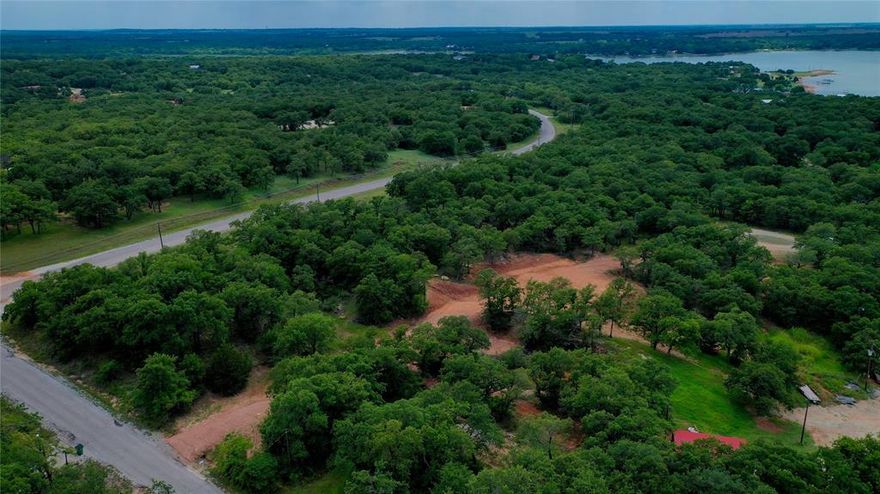 Find your perfect hidden getaway with tree top dream filled views of Lake Nocona. These 3 lots are an Ideal location to build among a private area with security at the gate so no worries when you drive away. Deed restrictions don’t allow mobile homes, but with only a minimum 1000 square foot home requirement, your choices are not limited. Desire a better view; take it up a notch & add a second floor with a deck. Imagine that elevated view of Lake Nocona every morning & to say the least about those sunset evenings. Lots of room left to make your outdoor entertaining area. Nothing like the smell of outside cookouts to draw in friends & neighbors. Boat ramp is just around the corner where you can swim, fish, dock the boat, or just sit & enjoy watching others. Tree coverage is also offered so don’t forget to grab a seat before you head out. Relax in the designated RV-camping area while you build or invite friends & family for an extended stay. Small air travel is not a problem as the community has a landing strip. Golfers at heart can experience the 18-hole golf course. If you want a slower pace day, get the trolling motor & hit the private Leisure Lake for just you against the fish challenge. Make it a priority to take the short trip to Nocona to expose yourself to all the happenings going on year-round. Lots of local merchants provide food, coffee, clothing, flowers, barbers, stylists, art, photography, convenient stores, groceries, just to name a few. Local hospital & pharmacy. Local Brewery & wineries in surrounding area. Scoot across the Red River to one of the Oklahoma Casinos. Come see for yourself what this rural community has to offer. Coming soon will be the newly remodeled Clubhouse, 19th Hole, Pro Shop, & with fingers crossed incorporate some golf tournaments if that is possible. Lots of positive turn-a-rounds for the HOA in recent coming dates. Access with an agent only.  A new survey will need to be completed to determine exact lot size & boundaries.