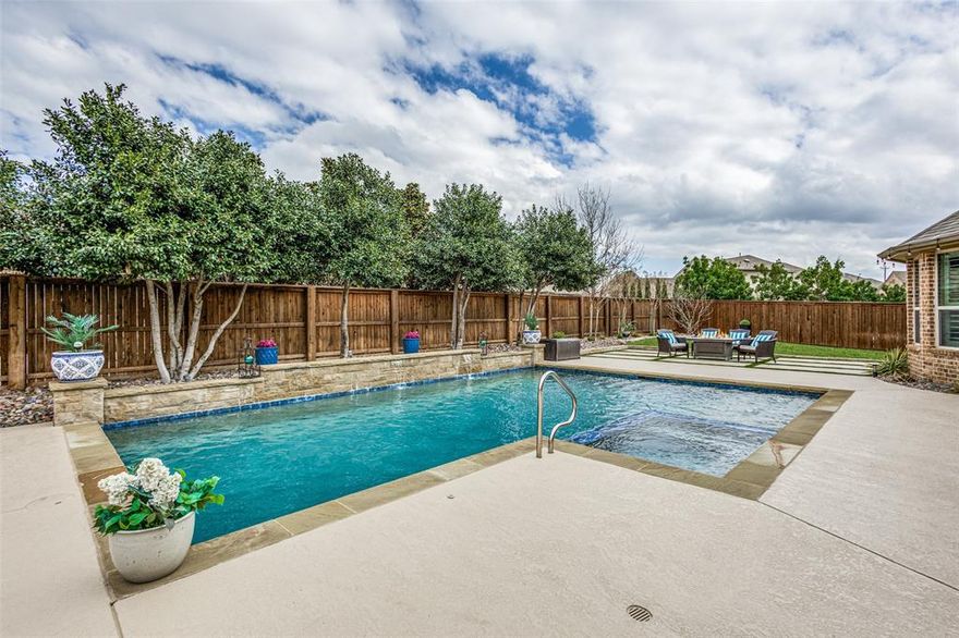 Meticulously maintained and shows like a model home, this property offers exceptional spaces for entertaining and everyday living. A separate wing includes two bedrooms, a large bathroom, and a private game room or living area—ideal for guests or multigenerational living. The media room features a state-of-the-art theater system for an immersive viewing experience. The backyard is designed for entertaining with a large pool and a covered patio equipped with an automatic screen. A spacious side yard provides room for pets or outdoor play. Inside, the home showcases high ceilings, plantation shutters throughout, and high-end finishes. The kitchen features a large island, abundant cabinet and counter space, and a stainless steel backsplash. The dining area includes a striking chandelier and overlooks the pool. The three-car garage is equipped with built-in cabinets, drawers, extensive storage, and epoxy flooring. The primary suite offers a spacious bedroom, a bathroom with separate sinks and a dedicated cosmetic vanity, and a custom closet with built-in cabinetry and direct access to the laundry room. Community amenities include a large fitness center, parks, playgrounds, a restaurant, three pools, and a lake. Conveniently located within walking distance to highly sought-after Prosper ISD schools.