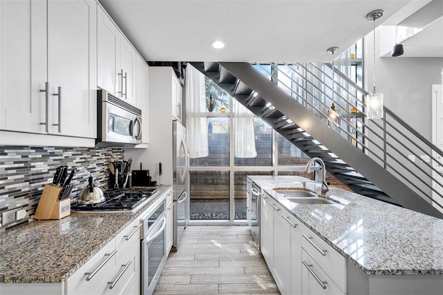 Discover the perfect blend of style and convenience in the cultural heart of Fort Worth with this stunning corner townhome. Situated next to the pool and featuring one of the largest backyards in the community, this home offers urban living at its finest. The expansive two-story windows flood the space with natural light, enhancing the home’s open and airy ambiance.

The interior showcases farmhouse-inspired charm with a full shiplap accent wall in the living and dining area, seamlessly connected to the open kitchen. Equipped with stainless steel KitchenAid appliances, granite countertops, and custom lighting and fans, the kitchen is both functional and stylish. Upgraded flooring throughout includes wood-look tile downstairs and in wet areas, with rich hardwoods upstairs.

The extra-large owner’s suite is a private retreat, complete with an updated double vanity, a stone floor shower, a luxurious six-foot soaking tub, and ample storage. A custom closet system adds an extra touch of luxury. The second bedroom is equally impressive, offering a full bath, custom Elfa shelving.

Step outside to an entertainer's paradise, featuring a double patio, a full outdoor kitchen, and a gated side yard perfect for relaxing or hosting gatherings. The oversized two-car garage provides additional convenience, while the unbeatable location places you close to Trinity Park, shopping, dining, and the vibrant W 7th district.

This home is a rare find, combining exceptional design, thoughtful upgrades, and an unbeatable location. Don't miss the chance to make it yours!