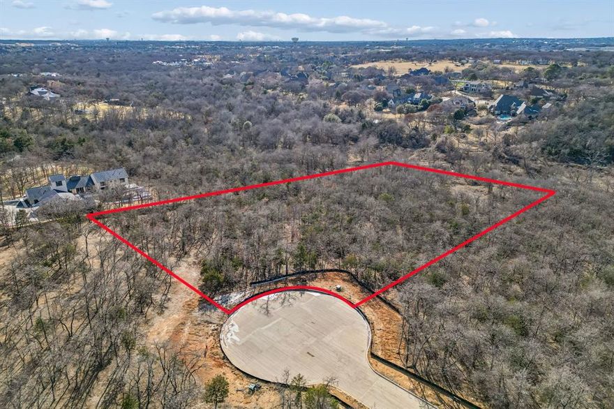 Discover an extraordinary opportunity to build your dream estate on one of Southlake's most coveted homesites. This exceptional cul-de-sac lot offers the perfect canvas for discerning buyers seeking ultimate luxury living within award-winning Carroll ISD. Spanning on a generous 1.52 acres, this premium homesite boasts breathtaking proximity to Lake Grapevine with mature trees and a tranquil natural setting.

Designated for construction by Willow Tree Custom Homes, renowned for meticulous craftsmanship and sophisticated architectural excellence. Their expertise ensures your custom luxury estate will be built to the highest standards of quality and design. Nestled within a distinguished estate community, The Conservation offers the perfect balance of seclusion and accessibility. 

Zoned to Carroll ISD, consistently ranked among Texas's premier school districts with nationally recognized academic and athletic programs. Minutes from Southlake Town Square's upscale amenities, DFW Airport, and major corridors. Lake Grapevine's boating, fishing, and trails are virtually at your doorstep. This is a rare opportunity to secure one of Southlake's finest remaining estate lots.