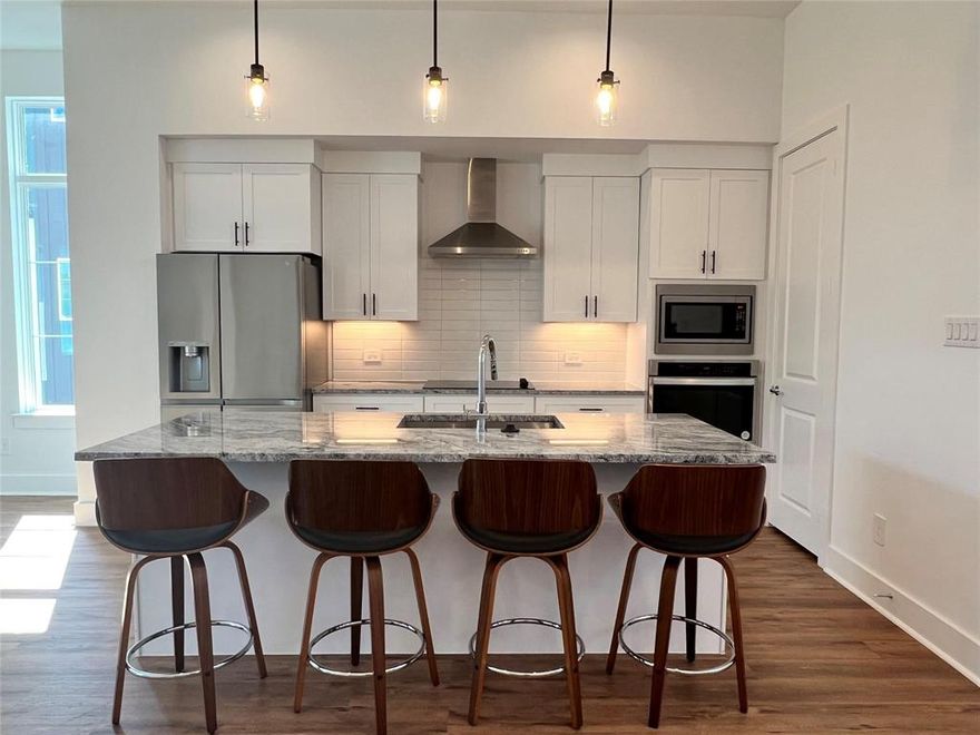 A rare opportunity to own modern construction in Mustang Station at an exceptional value.  

Welcome to Residence #201 at The Terraces on Bee Street, a move-in ready, three-story corner residence ideally located in the heart of Farmers Branch and the DFW metroplex. Natural light pours in from multiple exposures, creating a bright, inviting atmosphere unique to corner residences.
The open-concept main level is defined by 11-foot ceilings, expansive windows, and wood flooring throughout, offering a seamless space for both everyday living and entertaining. The kitchen is thoughtfully appointed with a large island, soft-close cabinetry, sleek finishes, and a stainless-steel refrigerator, blending modern design with functionality.

The primary suite serves as a private retreat, featuring an oversized walk-in shower, double vanity, and spacious walk-in closet.
Situated in one of the area’s fastest-growing neighborhoods, this residence offers convenient access to restaurants, local farmers markets, grocery stores, and the DART station, making commuting and dining effortless. Flexible HOA leasing with minimal restrictions adds long-term versatility and investment appeal.

Well-positioned within the current market, this residence presents a compelling opportunity in a highly desirable community. Schedule your private showing to experience it firsthand.