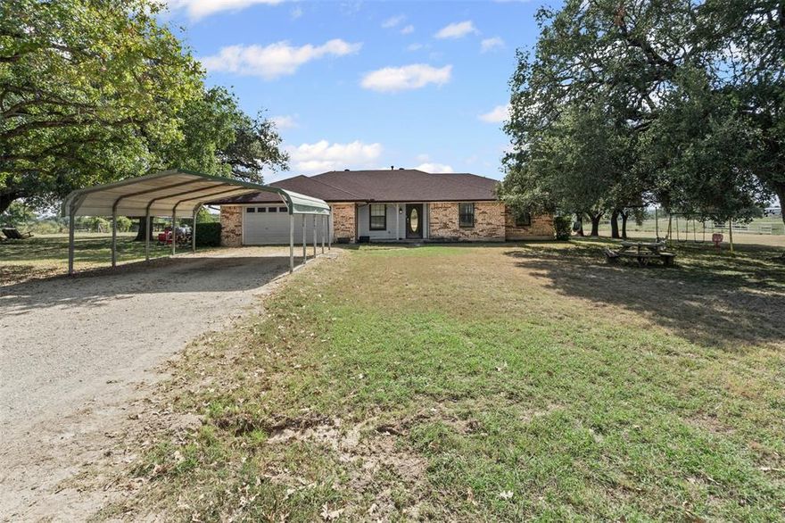 Sunsets, space, and serenity set on 4 peaceful acres in Granbury, this property offers the perfect blend of quiet country living and practical amenities. The spacious 4 bedroom, 2 bath home features an open layout filled with natural light and hilltop views that stretch for miles. A cozy fireplace anchors the main living area, creating a warm and inviting space for relaxing evenings or family gatherings.  Outdoors, you'll find a large detached shop for projects, storage, or business use, plus a dedicated RV cover with electric and its own septic hookup, ideal for guests, full-timers, or travel enthusiasts. With no HOA, you’ll have the freedom to create the lifestyle you want, whether that’s gardens, animals, or future expansions. 
And when it comes to evenings, this property truly shines, enjoy spectacular Texas sunsets year round, and on July 4th and New Year’s, watch the sky light up with fireworks from your own backyard, thanks to panoramic views of nearby celebrations.  All this just minutes from Lake Granbury, historic downtown, local dining, and top-rated Granbury ISD schools — with quick access to Hwy 377 for an easy commute.