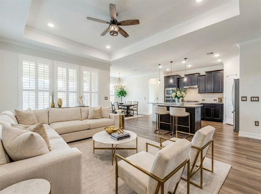 Welcome to this beautifully upgraded 3 bedroom, 2 bath home located in the highly sought-after 55+ Del Webb community within Trinity Falls where active living, nature, and community come together. Designed with both style and comfort in mind, this home features elegant tray ceilings, plantation shutters, stainless steel appliances, and durable wood vinyl flooring. The open-concept Summerwood floorplan creates an inviting atmosphere perfect for everyday living and entertaining. The chef’s kitchen is the heart of the home, showcasing granite countertops, a spacious island for gathering, and ample cabinetry, making meal prep and entertaining effortless. The primary suite serves as a private retreat featuring a spacious walk-in shower. Step outside to your extended covered patio, offering the ideal space for outdoor dining, relaxing, or entertaining while enjoying peaceful Texas evenings. Living in Del Webb Trinity Falls means enjoying a truly exceptional active adult lifestyle. Residents have access to three amenity centers, three resort-style pools, pickleball courts, fitness and social spaces, and vibrant community activities year-round. The community is surrounded by nature with five scenic ponds, miles of walking and biking trails, a dog park, grandkid splash pad, and outdoor concert areas. This home offers the perfect blend of comfort, upgrades, and an incredible lifestyle in one of McKinney’s most desirable 55+ communities.