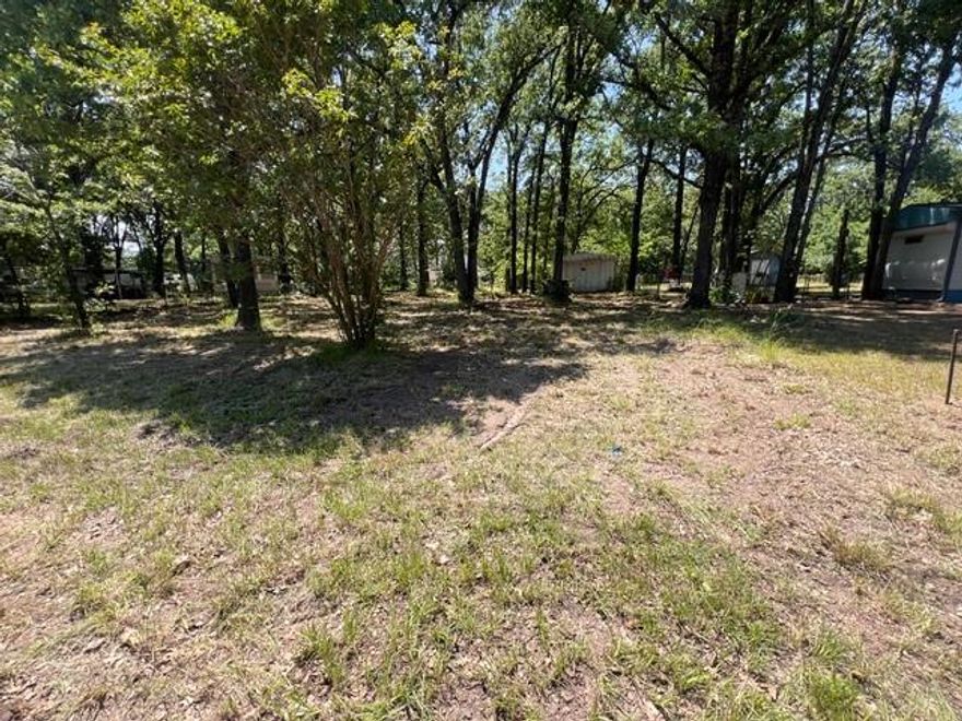 Tucked away in the lake community of Mantle Manors, this shaded lot offers a rare opportunity to own a peaceful slice of paradise. Surrounded by mature trees, the land provides natural privacy and a serene setting - perfect for building your dream home or bringing in a mobile home, as both are allowed. The lot includes an existing garage, providing immediate storage or workshop space as you plan your future build. This property offers flexibility for full-time living or a weekend escape. Gun Barrel City is known for its welcoming atmosphere and lakeside charm, just minutes from Cedar Creek Lake. Experience peaceful lake living at Cedar Creek Lake, one of the largest lakes in Texas, and home to great boating and bass fishing. Located about an hour drive from Dallas, this land delivers the ideal blend of seclusion and convenience. Whether you’re looking to build from the ground up or move in with a mobile home, this lot has the potential to bring your vision to life. Proudly Claim Your Piece of Texas!