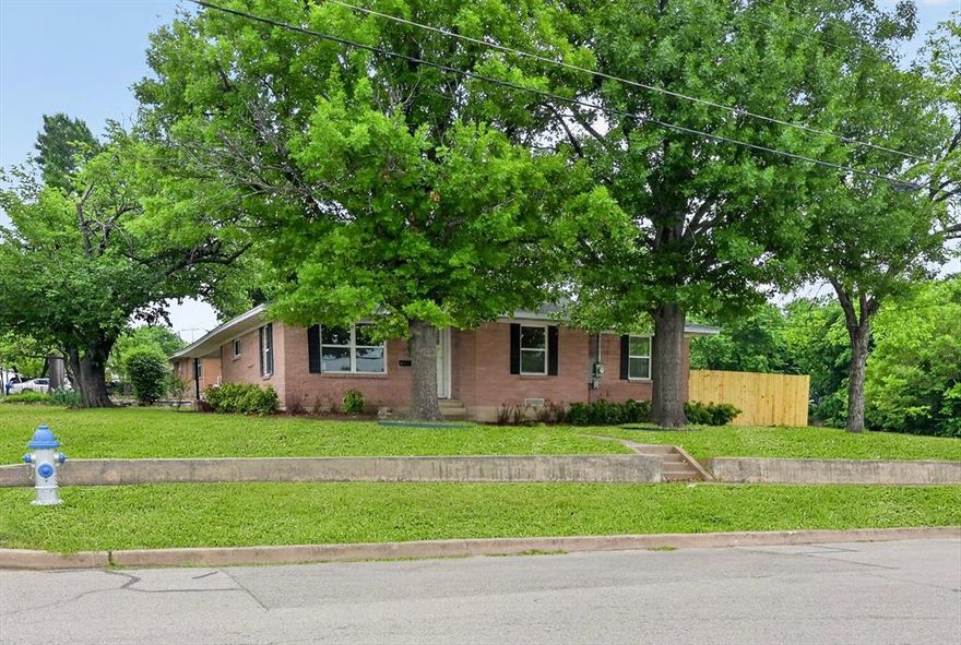 SELLER OFFERING $5,000 CLOSING COST CREDIT WITH A STRONG OFFER! Don't miss 801 S Tennessee Street - only three blocks from Historic Downtown McKinney sitting on a charming corner lot. The beautifully updated brick home is move-in ready with all-new flooring, new paint, a fully renovated kitchen featuring quartz countertops, tile backsplash, stainless steel appliances, and a stunning primary suite with a custom walk-in shower. Additional upgrades include brand-new tankless water heater and new windows throughout. Step outside to a private yard enclosed by a new picket fence - perfect for kids and pets - plus attached two-car covered parking with extra storage.  Located within walking distance of restaurants, coffee shops, farmers markets, and year round events, you will love the home and the rare location!