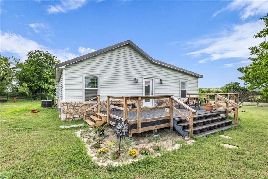 Located at 1037 County Road 2004 in Glen Rose, Texas, this beautifully updated 2-bedroom, 2-bath home sits on 1.192 fully fenced and gated acres in Somervell County—often referred to as the “Top of the Hill Country.” Just minutes from downtown Glen Rose, this property combines scenic views, modern updates, and peaceful country living within Glen Rose ISD.
The 1,326 sq ft home has been extensively remodeled, with major updates completed in 2021 including flooring, paint, kitchen, bathrooms, HVAC, appliances and a tankless water heater. A new metal roof was installed in 2024. Inside, enjoy an open layout filled with natural light, luxury vinyl plank flooring, decorative lighting, and a spacious kitchen featuring granite countertops, stainless steel appliances and ample cabinet storage.
The primary suite provides a comfortable retreat with a large bedroom and spa-style bathroom. Additional highlights include central electric heating and cooling, ceiling fans throughout and a functional single-story design.
Step outside to a 20’ x 24’ front porch deck that captures stunning North Texas hilltop views, including rolling hills and unforgettable sunsets. The acreage is ideal for animals, gardening or future improvements, with no known restrictions. A private 450-foot deep well supplies clean water to the home and outdoor faucets, with county water available nearby if desired. The property also includes a covered carport with added storage space.
Conveniently located near the Paluxy River, Dinosaur Valley State Park and Fossil Rim Wildlife Center, this Glen Rose property delivers a rare opportunity to enjoy Texas Hill Country views, wildlife and small-town charm while remaining within easy driving distance of Granbury, Stephenville and the DFW metroplex.