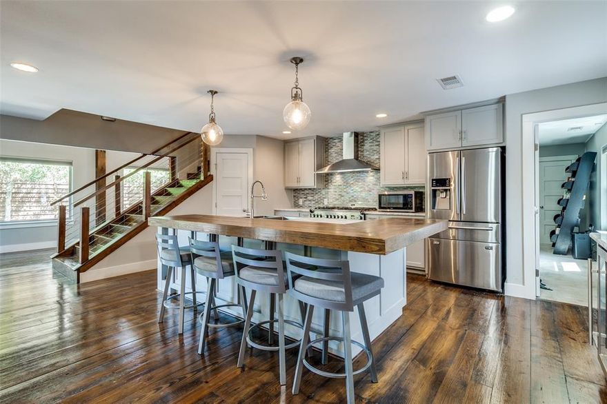 Urban custom-redesigned home truly stands out. It beautifully blends modern and rustic finishes, offering a unique living experience. This home is designed for both functional living and lavish entertaining. As you enter, you're greeted by an art gallery-style entrance that leads to a private outdoor oasis with a sparkling pool. The kitchen is a chef's dream, featuring a commercial 6-burner gas cooktop, ample cabinet space, and an oversized island with Carrera marble, all with views of the living area and outdoors. Plus, there's a convenient coffee bar in the breakfast nook. For flexible living arrangements or exceptional guest accommodations, there's a primary bedroom on each level. The first floor also includes a private third bedroom with an ensuite bath, tucked away behind the kitchen, which could easily serve as an office. Additionally, a versatile flex space at the entrance is perfect for an art exhibit, study, or play area. Upstairs, you'll find even more space to spread out in the large living area. Beyond its impressive design, this home boasts a fantastic location, incredibly close to Love Field, UT Southwestern, Parkland, and Children's Medical Center, with plenty of shopping and dining options nearby.