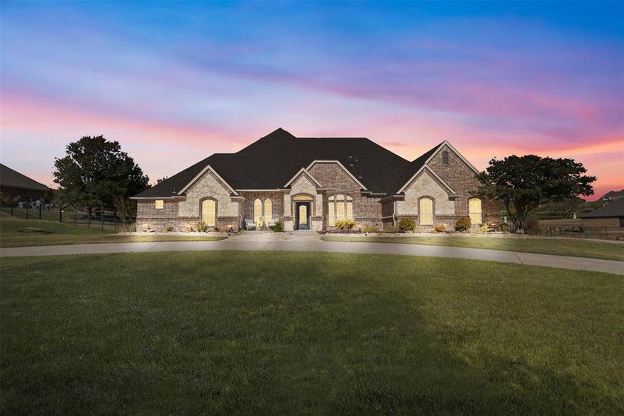 A home you’ll never want to step away from! Located in the gated Harbour View Estates near Eagle Mountain Lake, this stunning custom home sits on over an acre and comes with a fully equipped guest space, perfect for guests, family, or a private office. Inside, you’ll love the bright open layout with two living areas, a private study, a beautiful stone double-sided fireplace, and a chef-inspired kitchen. The primary suite offers a true spa-like escape with a jetted tub, walk-in shower, and oversized organized closet.
A spacious bonus room just off the main living area features a half bath and it has direct access to the pool.  Two bedrooms on the main floor share a Hollywood style bath.
Upstairs, the game room can flex as a 4th bedroom, media room, or kids’ retreat 
Step outside to your own backyard oasis featuring a custom pool with water feature, spacious covered patio, fire pit, and a stone cabana prepped for an outdoor kitchen. 
Enjoy community pools, trails, a playground, and quick access to highways and shopping.