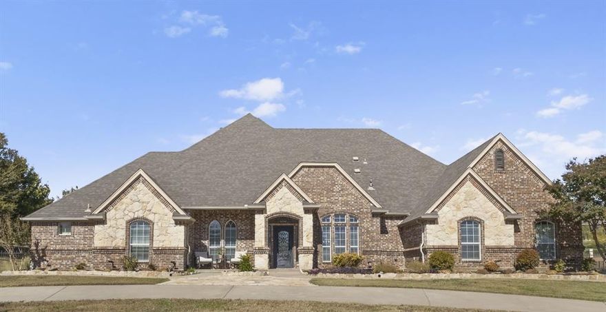 A home you will never want to step away from! Located in the gated Harbour View Estates near Eagle Mountain Lake, this stunning custom home sits on over an acre and comes with a fully equipped guest space, perfect for guests, family, or a private office. Inside, you’ll love the bright open layout with two living areas, a private study, a beautiful stone double-sided fireplace, and a chef-inspired kitchen. The primary suite offers a true spa-like escape with a jetted tub, walk-in shower, and oversized organized closet.
A spacious bonus room just off the main living area features a half bath and it has direct access to the pool.  Two bedrooms on the main floor share a Hollywood style bath.
Upstairs, the game room can flex as a 4th bedroom, media room, or kids’ retreat 
Step outside to your own backyard oasis featuring a custom pool with water feature, spacious covered patio, fire pit, and a stone cabana prepped for an outdoor kitchen. 
Enjoy community pools, trails, a playground, and quick access to highways and shopping.