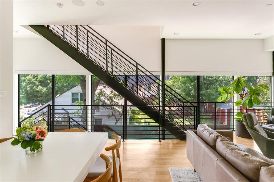 Step into this architecturally significant single-family home, masterfully designed by AIA award-winning architect Josh Nimmo. Nestled in the heart of East Village—just steps from the upcoming The Central development and minutes from Uptown, Lower Greenville, and Knox-Henderson—this home offers the perfect blend of location, design, and lifestyle.

The first floor welcomes you with oversized sliding glass doors that seamlessly connect indoor and outdoor living. Enjoy a private fenced yard featuring elegant black Tejas stone, a cozy firepit, and a stunning Japanese maple—a true urban oasis.

Inside, you’ll find 3 spacious bedrooms plus a dedicated office, two private balconies, and a striking two-story wall of glass that floods the home with natural light. Premium finishes and thoughtful upgrades abound: Sonos surround sound, automated shades, Lutron Caseta smart switches and dimmers, Bosch appliances, museum-finish walls, solid core doors, and beautiful white oak hardwood floors.

This is a one-of-a-kind design with no HOA, no shared walls, and no compromises—just elevated modern living in one of Dallas’ most dynamic neighborhoods.