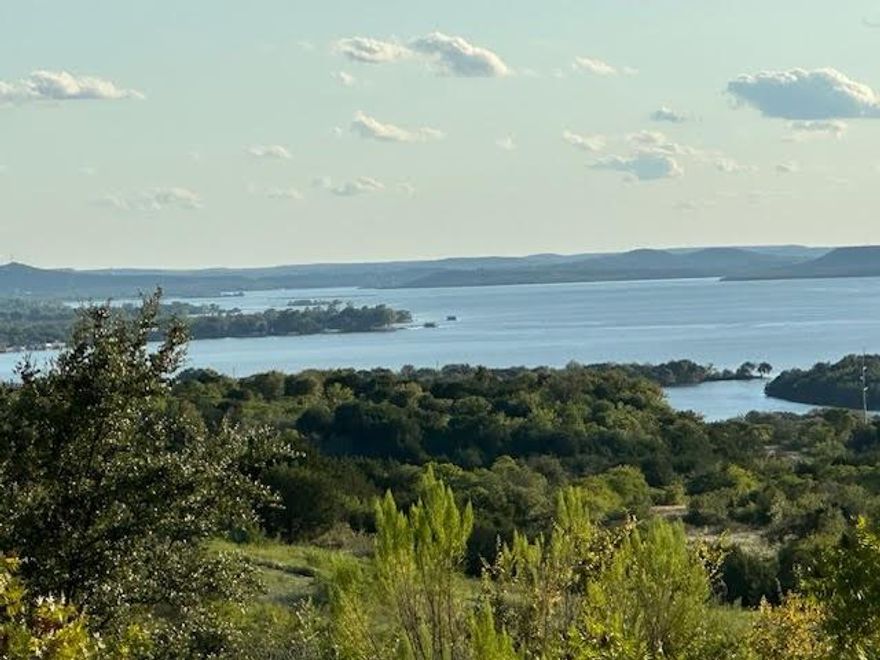 Lovely two acre lot atop the ridge overlooking The Hills and the north end of Possum KIngdom Lake. This lot has a magnificent view of the surrounding community and the lake. The adjoining two acre lot is also for sale by the same owner. Lot ownership permits the use of all the neighborhood amenities including; clubhouse with pool and fitness center, boat storage, community dock, boat ramp, cabin with restrooms and picnic area with covered patio, lakefront area, fishing pond, and twenty miles of private roads behind the gates.