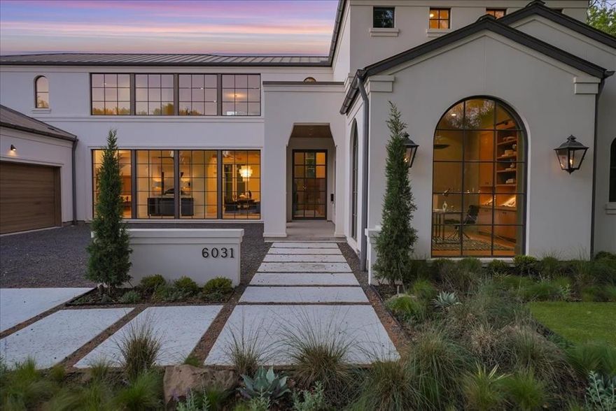 New Construction in the fairway of Preston Hollow. Discover a harmonious blend of timeless elegance and contemporary design at 6031 Lupton Dr. Nestled on a .43-acre lot in the prestigious Fairway of Preston Hollow, this 7,009-square-foot estate features 5 bedrooms, 5.2 baths, and a three-car garage, offering both luxury and comfort in every detail. The exterior draws inspiration from the iconic Santa Barbara style, merging the romance of Spanish Revival architecture with a fresh coastal aesthetic. Handmade details transition seamlessly from the outside in, with corbel arched openings, beamed ceilings, and warm wood tones enhancing the home’s inviting atmosphere. The interiors are adorned with limestone and plaster fireplaces, custom vent hoods, and decorative cement tiles, all contributing to the classic Mediterranean ambiance. Inside, rift-cut white oak cabinetry, warm white walls, and a mix of travertine and quartzite stone create a modern yet welcoming feel. The thoughtful balance of polished nickel with wrought iron and bronze tones adds a touch of sophistication, ensuring the home retains its Mediterranean roots while embracing contemporary style. This home also boasts two laundry rooms for added convenience, a dedicated office space, and expansive living areas perfect for both relaxation and entertaining. The backyard is an inviting retreat featuring a covered patio, built-in outdoor grill, and a sparkling pool, perfect for relaxing or entertaining. 6031 Lupton Dr. is not just a home; it's a masterpiece of design, where traditional craftsmanship meets modern luxury. Experience the best of both worlds in this exquisite Preston Hollow home.