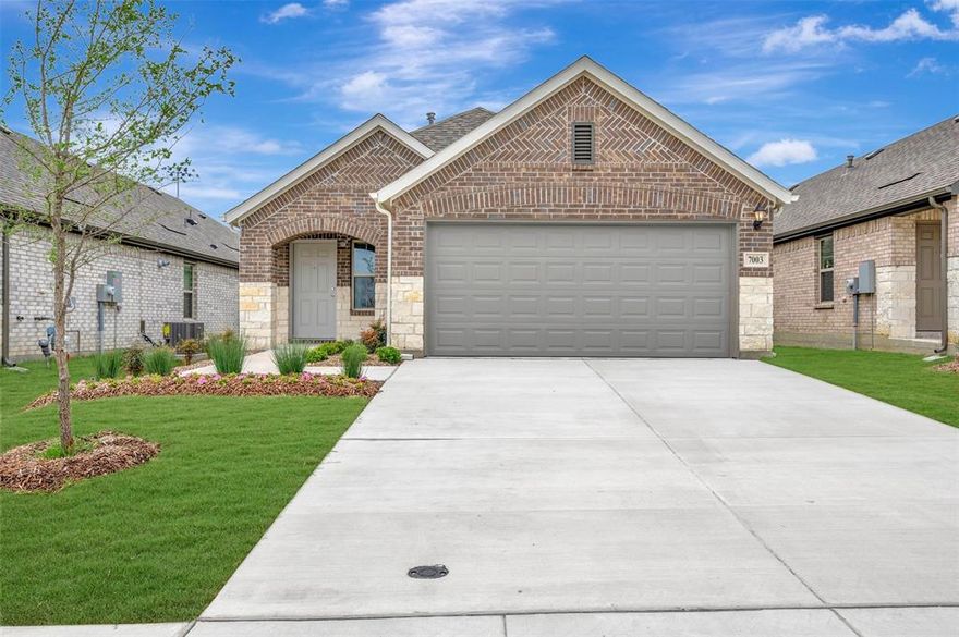 Built by M-I Homes. Welcome to 7003 Butterfield Drive in Sanger, TX, a charming single-story home offering 3 bedrooms and 2 full bathrooms—perfect for comfortable, low-maintenance living with a modern feel.

A covered front porch welcomes you into an open-concept layout where the kitchen, dining area, and family room flow effortlessly together. This central living space is designed for both everyday routines and easy entertaining, with the kitchen serving as the heart of the home and offering ample workspace and direct views into the main living areas.

The owner’s suite is tucked privately toward the back of the home and features a spacious bedroom, walk-in closet, and an en-suite bath designed for everyday comfort. Two secondary bedrooms and a full bath are positioned nearby, making them ideal for guests, a home office, or additional living flexibility.

Additional highlights include a covered patio for outdoor enjoyment, a dedicated utility area, and a 2-car garage for added convenience.

With its smart use of space, open living design, and single-level layout, this Quick Move-In home offers an easy, welcoming lifestyle in this desirable Sanger community. Schedule your visit today!