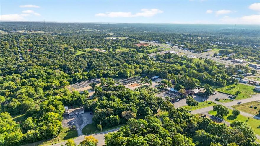 Excellent opportunity to own a versatile 4.01-acre site in Denison. The property includes a small storage warehouse with a roll-up door and an office, providing immediate functionality for a variety of uses. With over 260 feet of frontage on FM 691, the site benefits from strong visibility and exposure to ~8,100 vehicles per day. Less then 1,000ft from Texoma Parkway (12,600 VPD) and less than one mile from Highway 75 (~60,000 VPD). A large gravel parking area accommodates heavy equipment, fleet vehicles, or customer traffic with ease. The property is free of floodplain per FEMA maps and situated near Texoma Medical Center, Grayson County’s largest employer. This property is well-positioned for growth alongside the region’s expanding medical and commercial development.