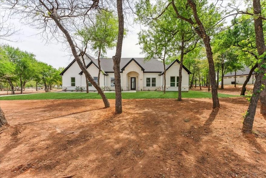 GA HOMES NEWEST NEW HOME CONSTRUCTION LOCATED ON 1 ACRE!!!!!!

This beautiful home is positioned near lake Granbury, offering unparalleled views and a serene atmosphere. Surrounded by towering, mature trees that provide year-round beauty and privacy, this home is a sanctuary for those seeking peace, comfort, and natural beauty.

The main kitchen features include a gas stove, POT FILLER FAUCET, custom cabinetry, and a spacious island perfect for entertaining. Adjacent to the kitchen is a cozy family room, where you can unwind by the fireplace while enjoying panoramic views of the peaceful outdoors.

Don't waste time and come see this home as it is priced to sell and wont last on the market very long! 

Want to enjoy your time on the lake? The nearest Boat ramp is just 3 MINUTES AWAY. (boat ramp located on Port O call Ct)