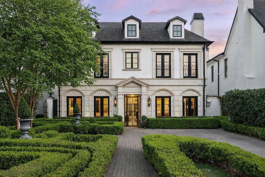 Swoon Worthy University Park custom built home with impeccable detail, walking distance to Highland Park Village and highly sought Bradfield Elementary. This timeless classic Georgian-styled home offers 4 bedrooms and a study in the main house plus an ensuite 5th bedroom in the separate detached quarters over the two car garage. Beautiful drive-up with boxwood maze garden leading to the impressive entry with wrought-iron and glass door. The stylish black and white marbled foyer is flanked by the formal dining room with double French doors and a handsome library with fireplace and built-in shelving.The open concept kitchen-living-breakfast area is ideal today's lifestyle, well suited for everyday living and entertaining. The chef's kitchen features a large eat-around marble island with professional grade  Viking appliances including a gas range, double ovens and a built-in refrigerator. The main living area is anchored by a fireplace and French doors opening to the covered terrace and outdoor living area with built-in grill. The primary bedroom with fireplace and sitting area is complimeted by a marble bath with dual vanities, soaking tub, separate shower and customized walk-in closet. Separate detached quarters over the garage add an additional 520 square feet (per DCAD) that are not included in the square footage bringing the total square footage to approximately 4500 square feet and is ideal for a 5th bedroom, second office or flex space. This very special property offers an incredible opportunity for those seeking a welcoming and luxurious home in one of the best locations in the Park Cities.