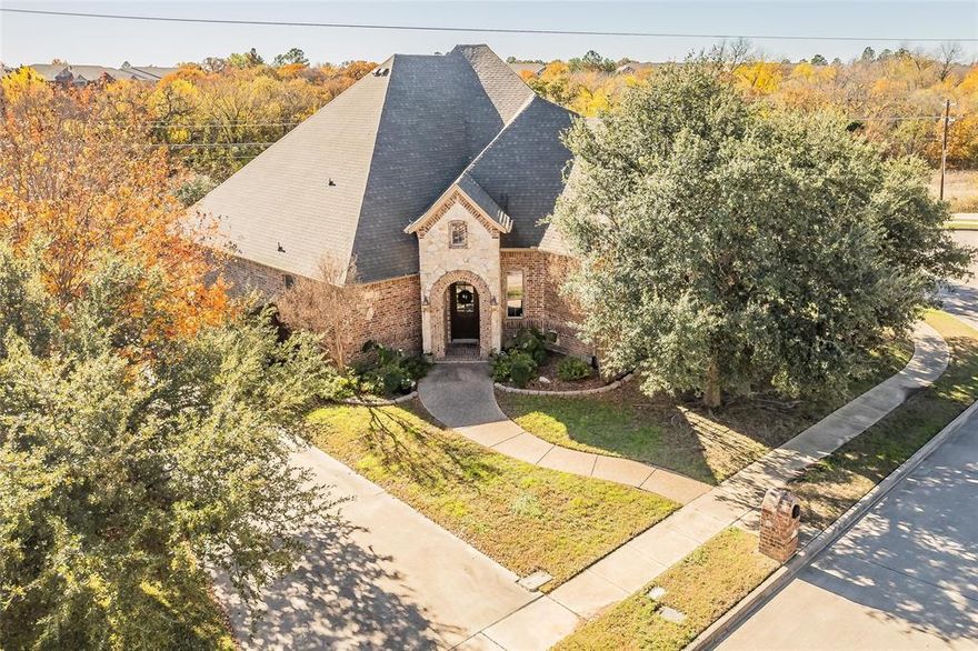 So many GREAT and UNIQUE features in this beautiful home. Flexible floorplan for todays multi-generational families with guest or mother-in-law area w-easy access to the 4TH car garage. 4 bedrooms, 2 living + office, 2 dining, 3 FULL baths. Quality craftsmanship thruout, crown molding, barrel ceilings, brick arches, custom cabinetry, butlers pantry & an abundance of storage. Main living has open floor plan, rock gas FP. Kitchen w-island, 5 burner GAS cooktop, double ovens, granite. All bedrooms on the FIRST floor. Separate master has HUGE WALK-IN CLOSET, WI shower and relaxing soaking tub. Second floor has a gameroom, living or a 5th bedroom plus half bath and its own AC. Electric gate to 4-car garage! Control AC as needed with 3 units, 2 downstairs, 1 up. Enjoy neighborhood amenities of walking trails, bike paths, park & nearby shops, dining, movie theatre & NRH Fire Dept. Don't miss this GEM! Home backs to 11 mile Cotton Belt & John Barclay walking & biking trail. NO REAR NEIGHBORS!